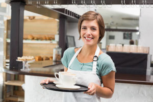 Waitress holding tray with cappuccinos